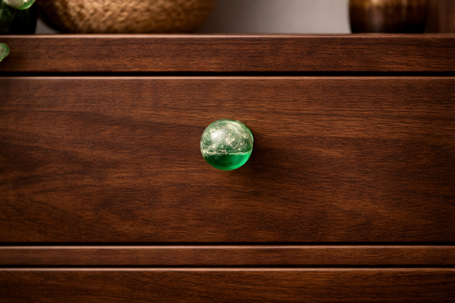 Handmade green resin cabinet knob with real dandelion seeds mounted on dark wooden drawer – botanical furniture hardware