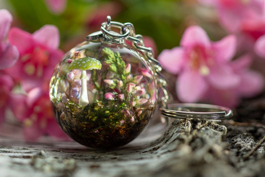 Keychain with real plants and green mushroom .
